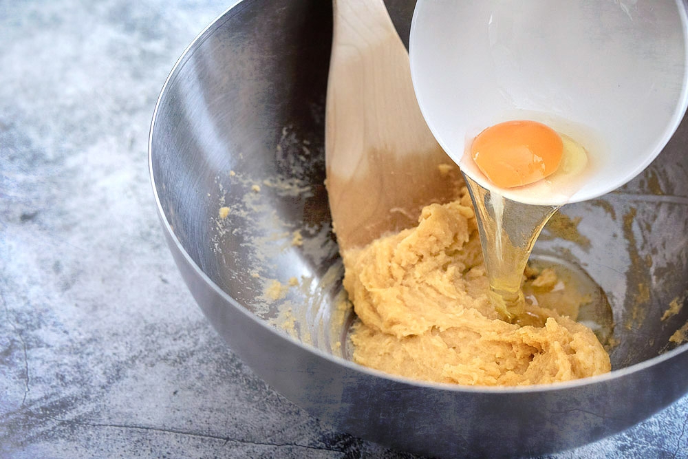 Add the eggs one at a time to the 'gougère' batter.