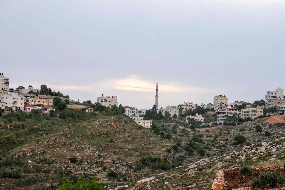 The minaret of a mosque rises amid buildings in the Palestinian village of Deir Jarir, east of the occupied West Bank city of Ramallah on April 25, 2024. ― AFP pic
