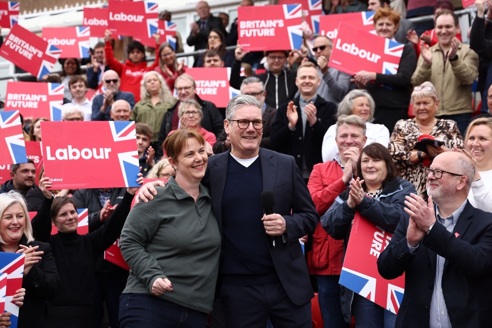 Britain’s main opposition Labour Party leader Keir Starmer embraces new East Midlands Mayor Claire Ward during a post local election rally in Mansfield, central England on May 5, 2024. ― AFP pic