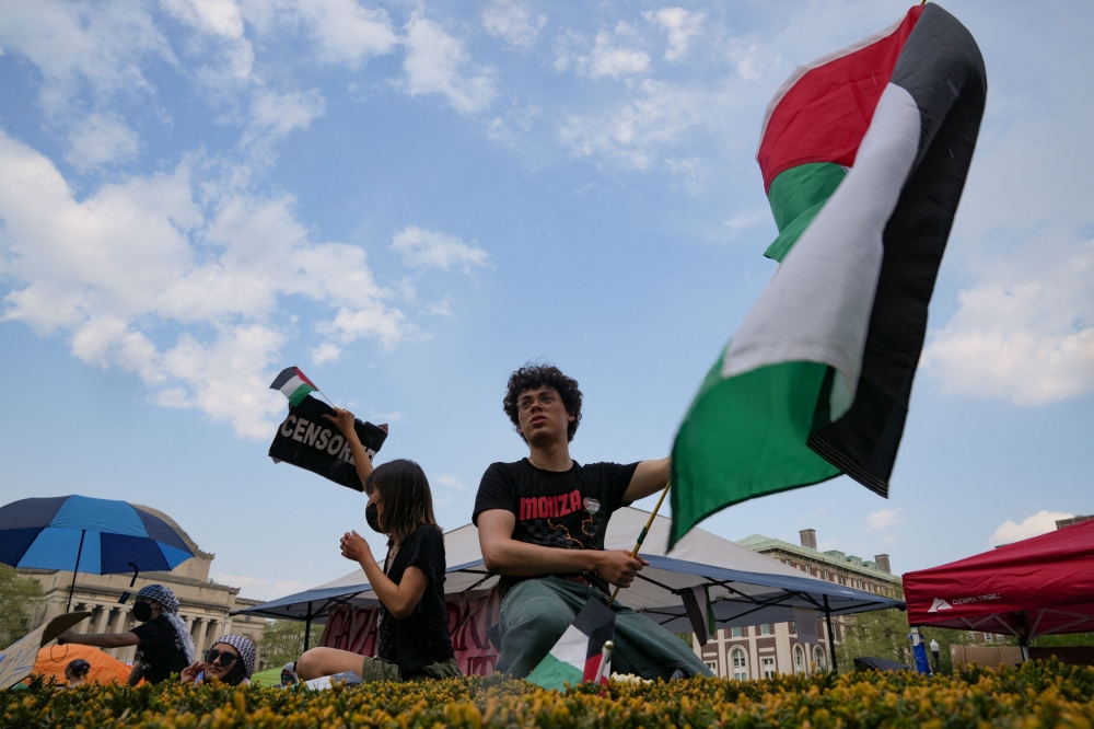 File photo of a protester holding a Palestinian flag as students rally on Columbia University campus at a protest encampment in support of Palestinians, despite a 2 pm deadline issued by university officials to disband or face suspension, during the ongoing conflict between Israel and the Palestinian Islamist group Hamas, in New York City. ― Reuters pic