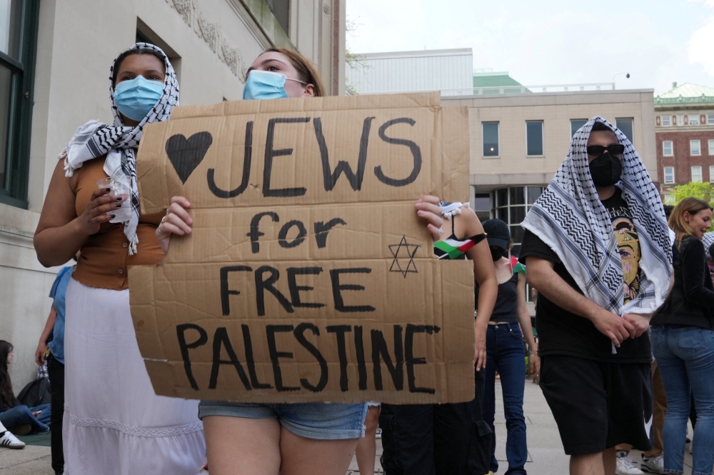 File  photo of a protester holding a sign as students rally on Columbia University campus at a protest encampment in support of Palestinians, despite a 2 pm deadline issued by university officials to disband or face suspension, during the ongoing conflict between Israel and the Palestinian Islamist group Hamas, in New York City, US, April 29, 2024. ― Reuters pic