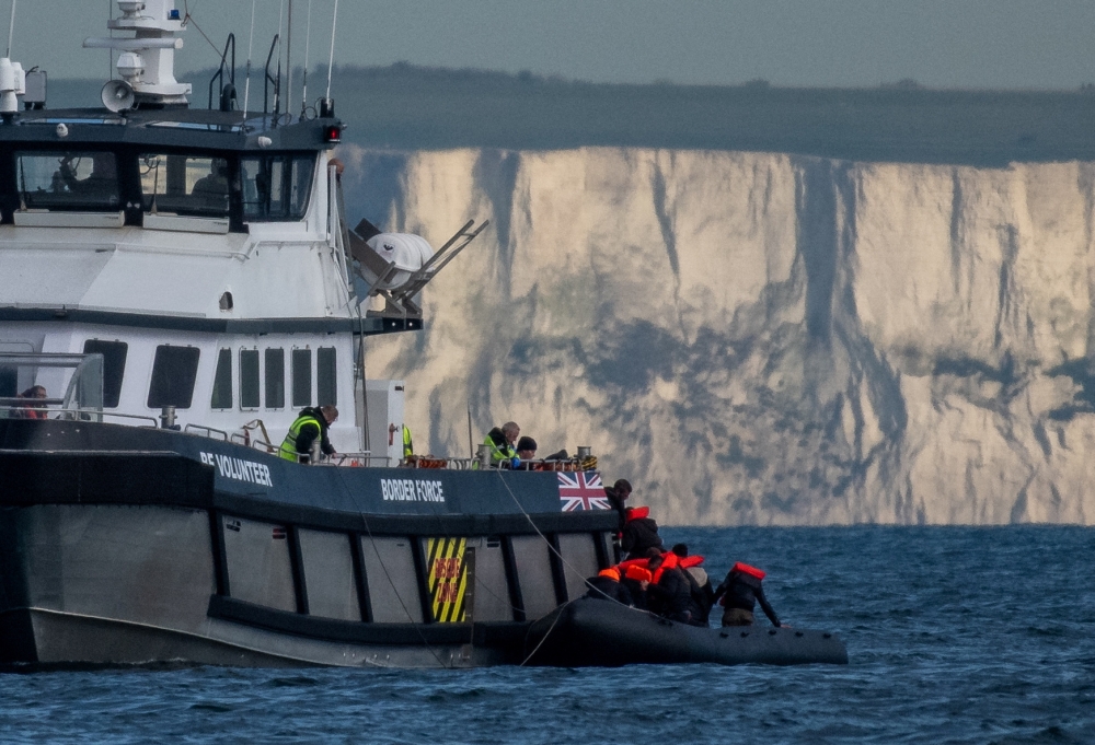 A British Border Force vessel picks up an inflatable dinghy carrying migrants in front of the white cliffs of Dover in the English Channel, Britain, May 4, 2024. ― Reuters pic