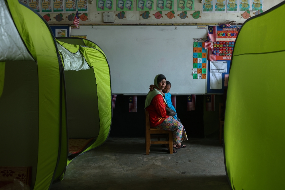 A total of 300 people from 69 families in this district were evacuated to a temporary relief centre after their villages were hit by flash floods today. — Bernama pic 