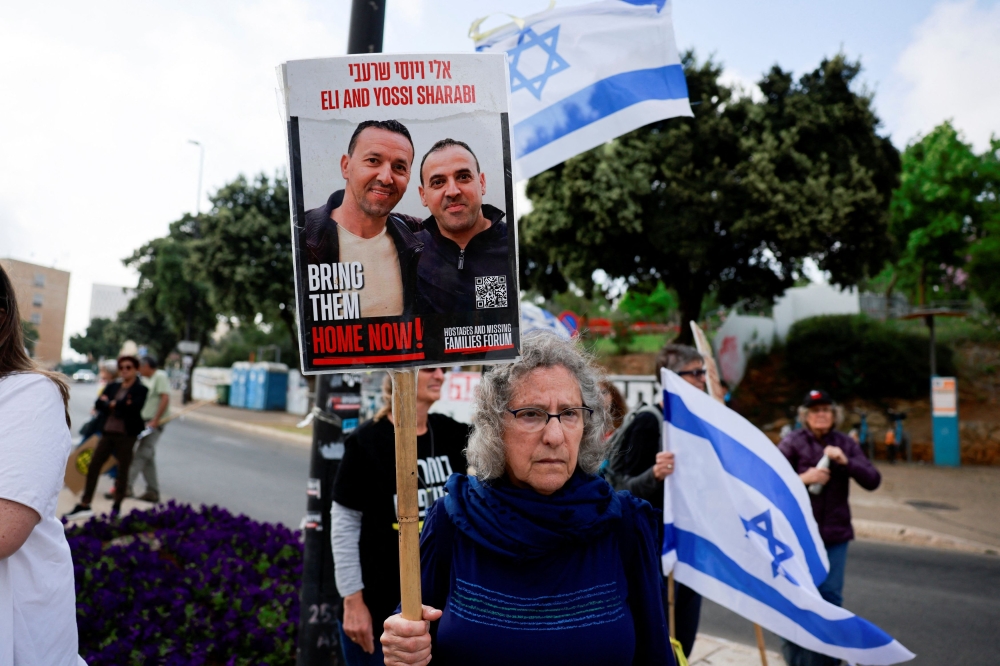 A woman holds a sign, as people take part in an anti-government protest, claiming that Israel’s government is ignoring the hostages who have been held in Gaza since October 7. — Reuters pic