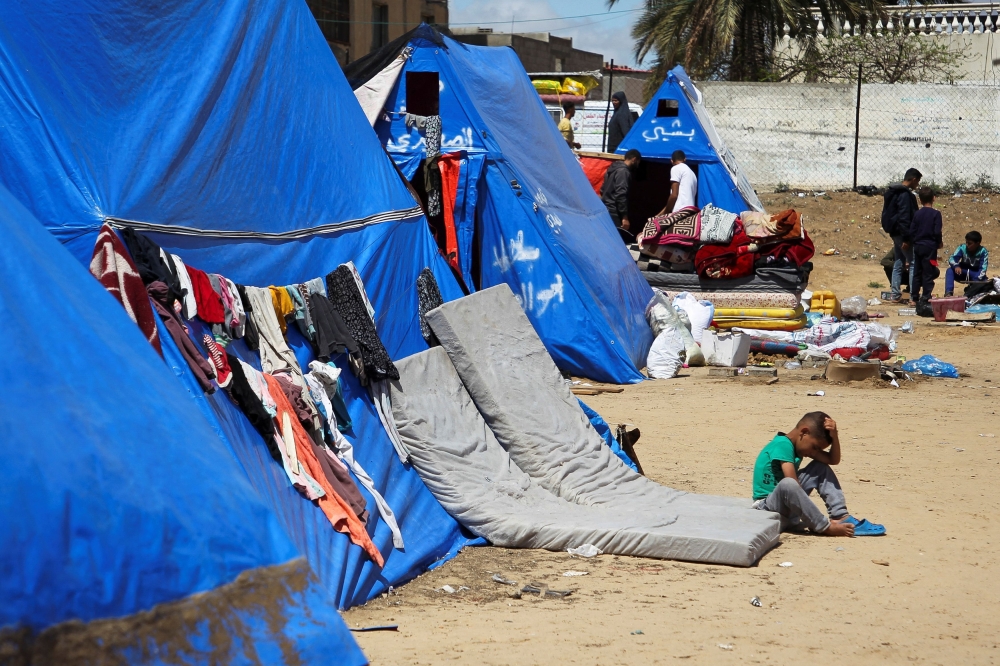 A displaced Palestinian child sits after the Israeli military began evacuating Palestinian civilians ahead of a threatened assault on Rafah, amid the ongoing conflict between Israel and Hamas, in Rafah, in the southern Gaza Strip May 6, 2024. — Reuters pic