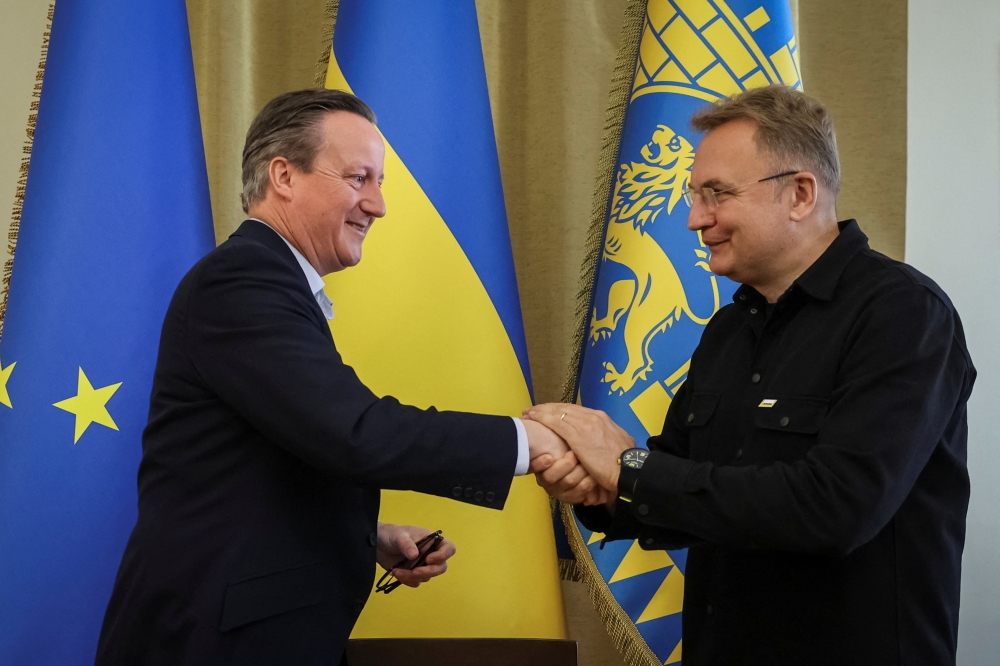 Britain's Foreign Secretary David Cameron and Lviv City Mayor Andriy Sadovyi shake hands at a joint meeting, amid Russia's ongoing invasion, in Lviv, Ukraine May 3, 2024. — Reuters pic