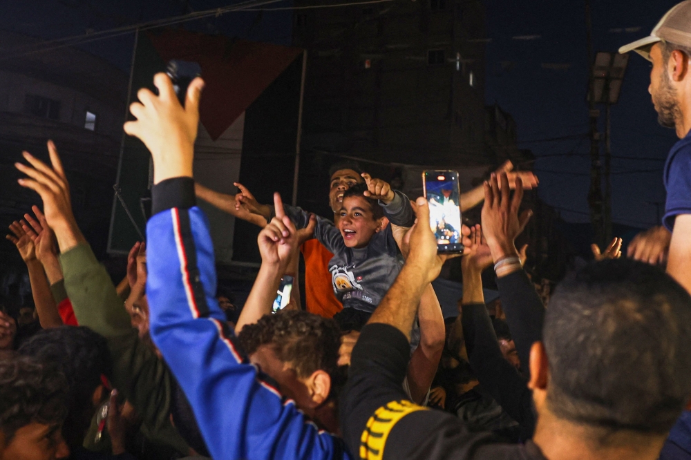 Palestinians celebrate in a street in Rafah, in the southern Gaza Strip, after Hamas announced it has accepted a truce proposal on May 6, 2024, amid the ongoing conflict between Israel and the Palestinian militant group Hamas. — AFP pic