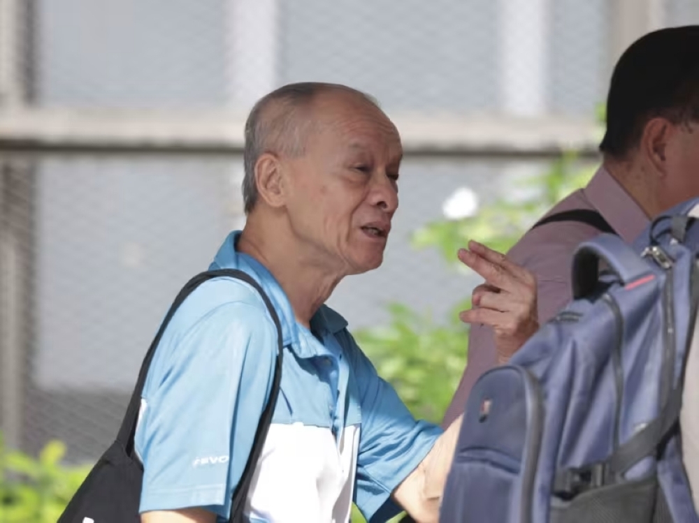 Lee Chook Lim gesturing as he was leaving the State Courts on May 6, 2024. — TODAY pic