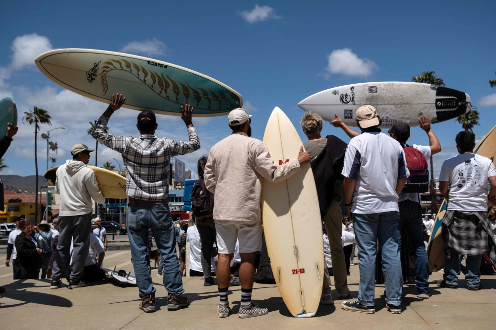 Members of the surfing community protest against insecurity after two Australians and an American surfers went missing last week during a surfing trip, in Ensenada, Baja California state, Mexico, on May 5, 2024. — AFP pic