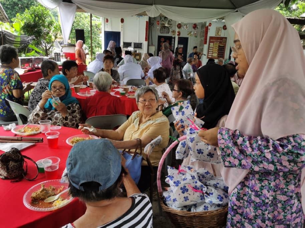 Volunteers mingle with former leprosy patients  at the Raya event in Sungai Buloh. — Picture courtesy of Zuraini Md Ali and Nor Hayati Hussain
