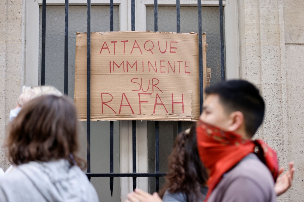 A placards reads ‘Imminent attack on Rafah’ as students occupy the street in front of the Sciences Po University building in support of Palestinians in Gaza, amid the ongoing conflict between Israel and the Palestinian Islamist group Hamas, in Paris, France, May 7, 2024.  — Reuters pic