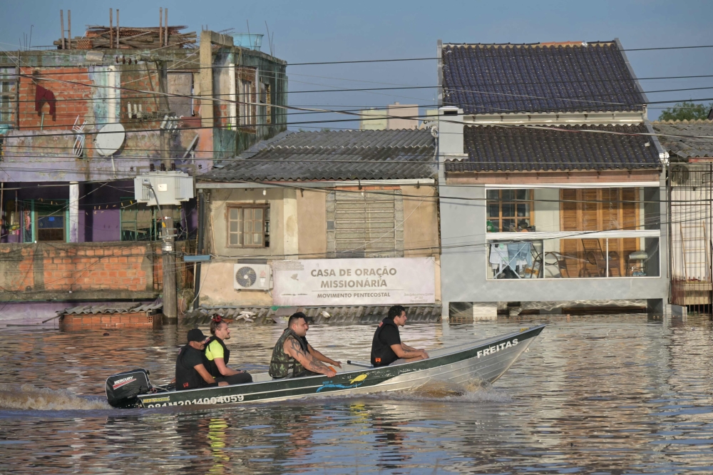 Rescuers search for people in the Humaita neighbourhood in Porto Alegre. — AFP pic