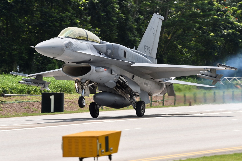 An RSAF F-16 landing on a public road in Lim Chu Kang during a media preview in 2016. — AFP pic