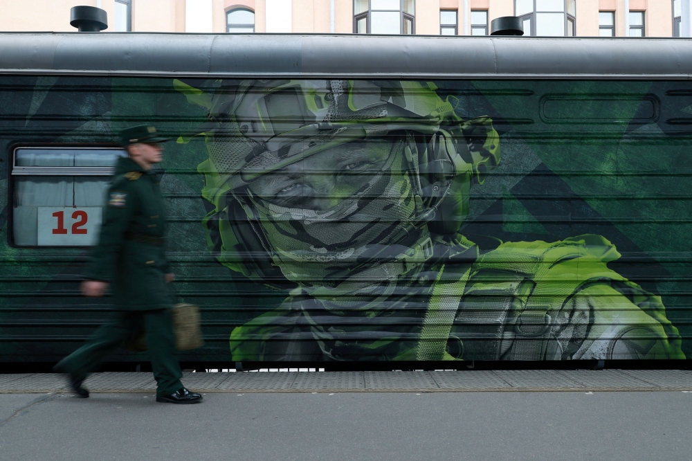 A Russian serviceman walks past a decorated train car during an exhibition transported by train that promotes the Russian army across the country’s regions, in Saint Petersburg, Russia May 4, 2024. — Reuters pic