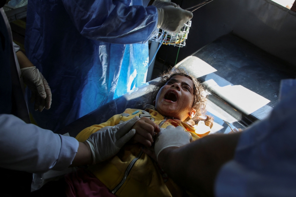 A Palestinian girl wounded in an Israeli strike in Rafah. — Reuters pic