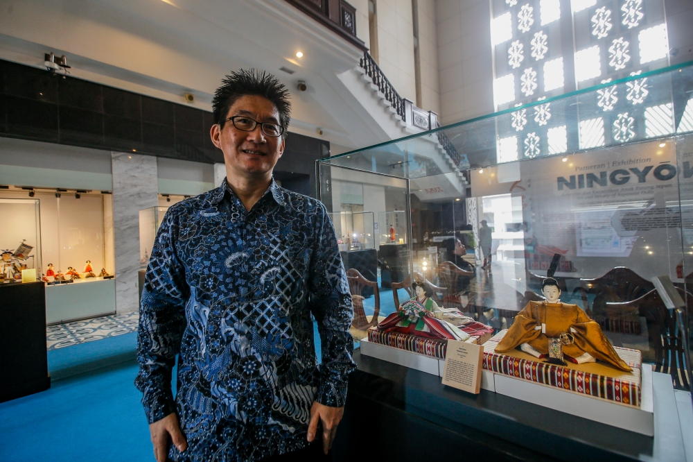 JFKL director Tsukamoto Norihisa with the Dairi-bina dolls meant to represent the Emperor and Empress from the Edo period (1603-1868). — Picture by Hari Anggara