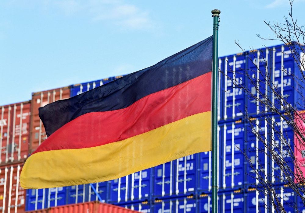 A German flag blows in the wind in front of a stack of containers at the harbour in Hamburg, Germany, February 24, 2022. — Reuters file pic