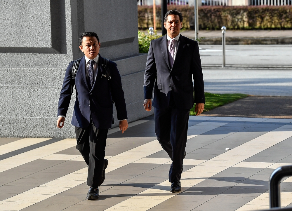 Segambut Bersatu Division deputy chief Adam Radlan Adam Muhammad (right) arrives for his trial at the Kuala Lumpur Sessions Court May 9, 2024. — Bernama pic