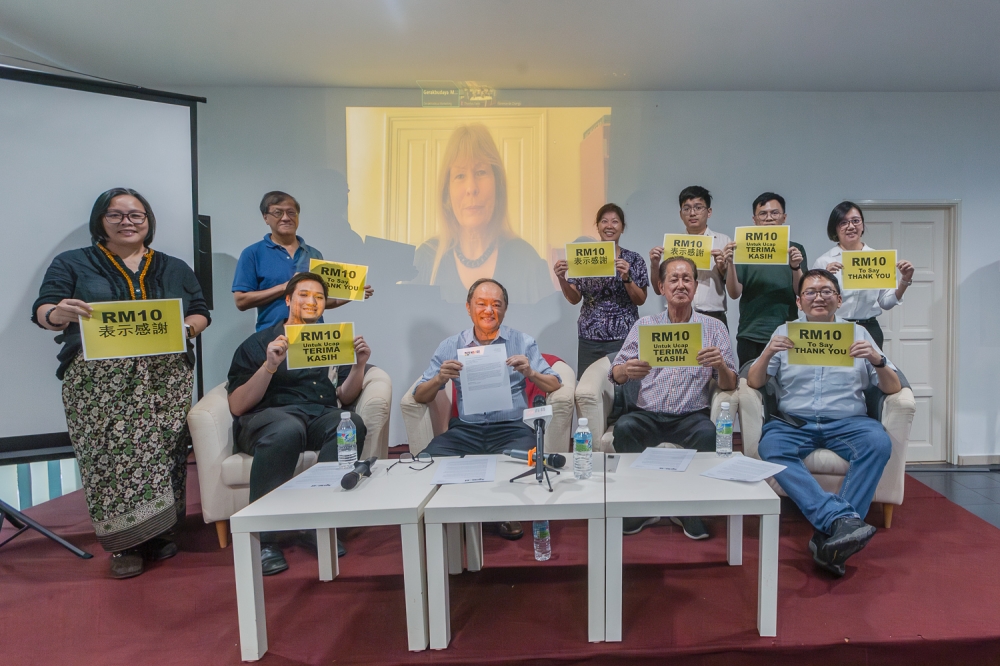 Sarawak Report editor Clare Newcastle-Brown appears on the screen during a group picture at Engage’s Freedom Fund press conference in Petaling Jaya May 9, 2024. — Picture by Raymond Manuel 
