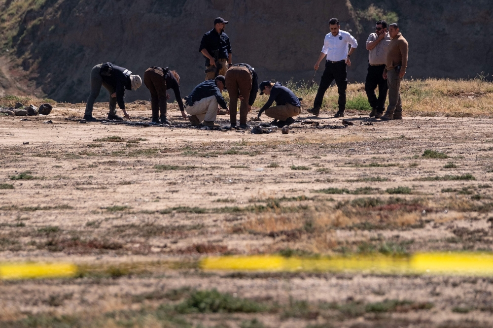 The friends had been camping in a remote beachside area when they were killed in what investigators believe was an attempt to steal their pickup truck. — AFP pic