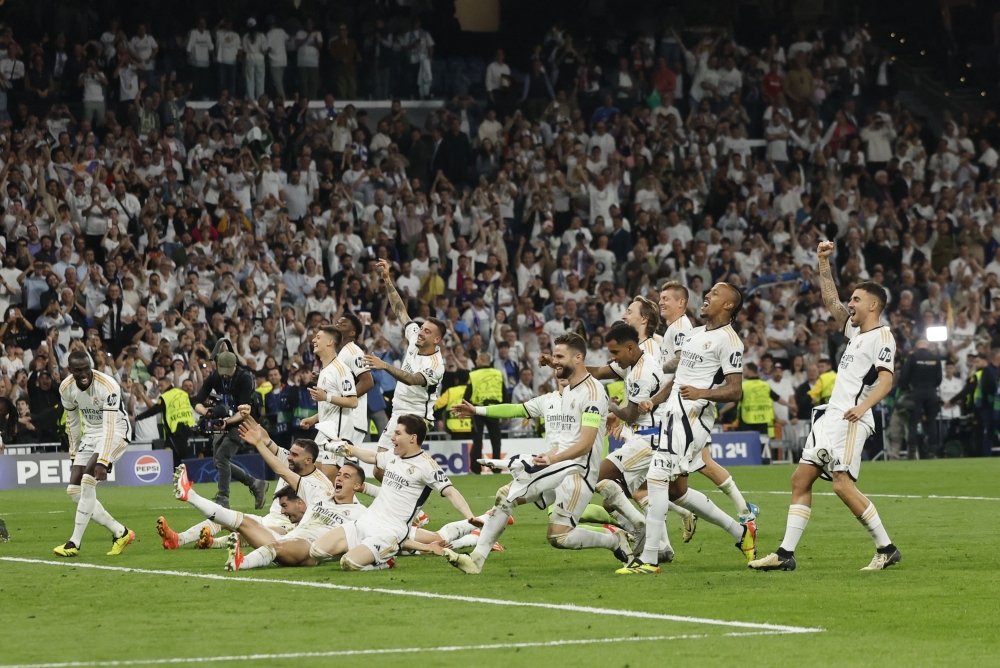 Real Madrid's players celebrate victory at the end of the UEFA Champions League semi final second leg football match between Real Madrid CF and FC Bayern Munich at the Santiago Bernabeu stadium in Madrid May 8, 2024. — AFP pic