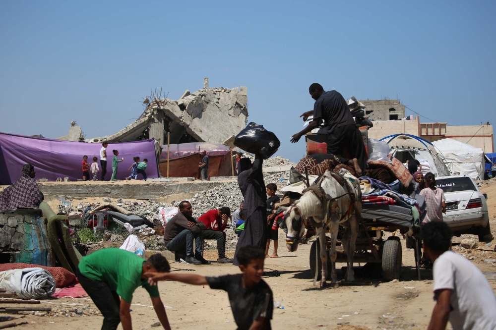 Displaced Palestinians load their belongings on the back of a horse-pulled cart as they flee al-Mawasi to a safer area in Rafah in the southern Gaza Strip May 9, 2024. — AFP pic