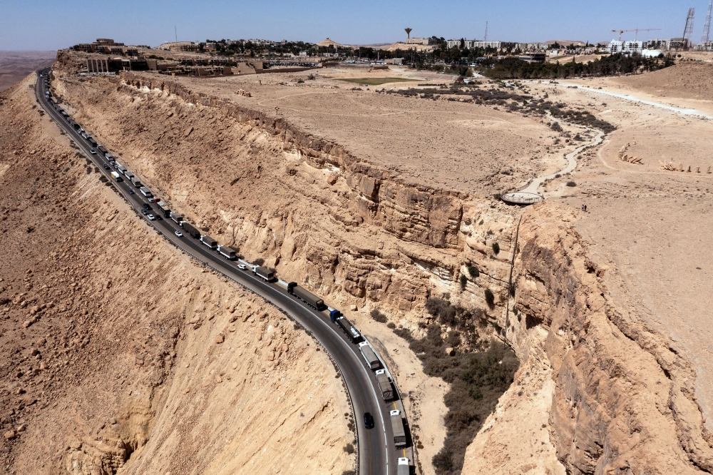 A drone view shows a trail of trucks lining up on a road near Mitzpe Ramon following a protest aiming to prevent humanitarian aid from arriving to Gaza. — Reuters pic