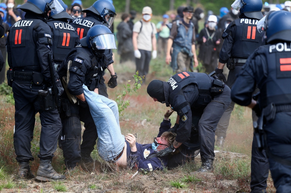 Protesters opposed to expansion of US electric vehicle maker Tesla’s  plant in Grueneheide near Berlin clashed with police as some of them attempted to storm the facility today. — Reuters pic