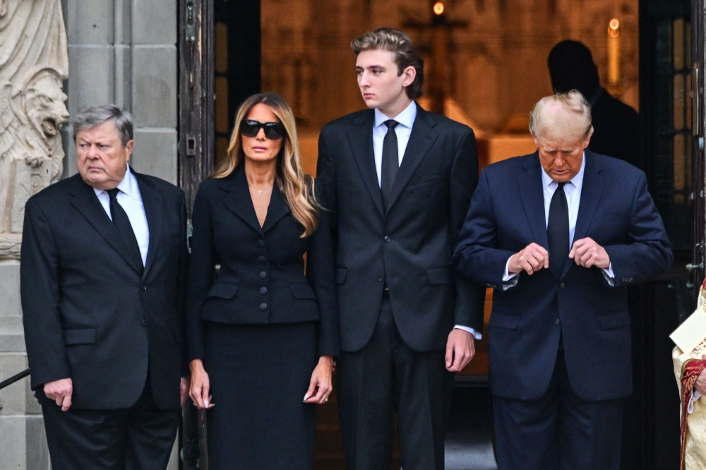 Barron (third from left), who has been largely shielded from the public eye, made global headlines this week when it appeared he would be the latest member of the Trump family to enter the political arena. — AFP pic