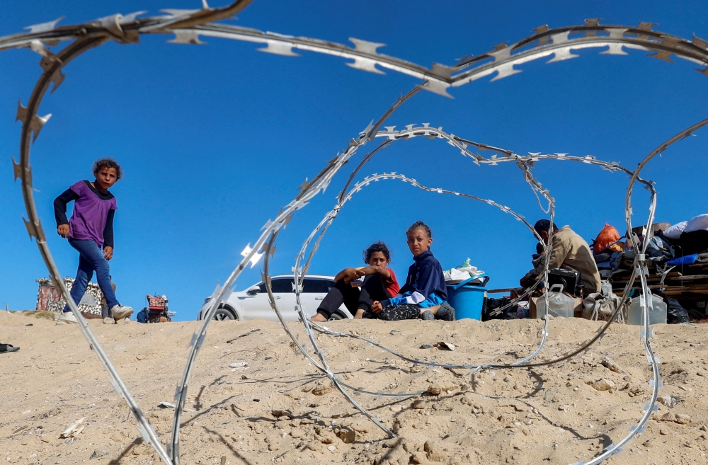 Palestinians sit to next to belongings as people flee Rafah after Israeli forces launched a ground and air operation in the eastern part of the southern Gaza city, amid the ongoing conflict between Israel and Hamas, in the southern Gaza Strip May 9, 2024. — Reuters pic