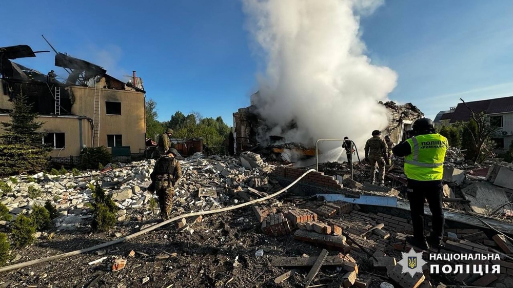 This handout photograph taken and released by the National Police of Ukraine on May 10, 2024, shows employees of the State Emergency Service extinguishing fires of private houses destroyed by a shelling in Kharkiv, eastern Ukraine, amid the Russian invasion in Ukraine. — Handout by National Police of Ukraine via AFP