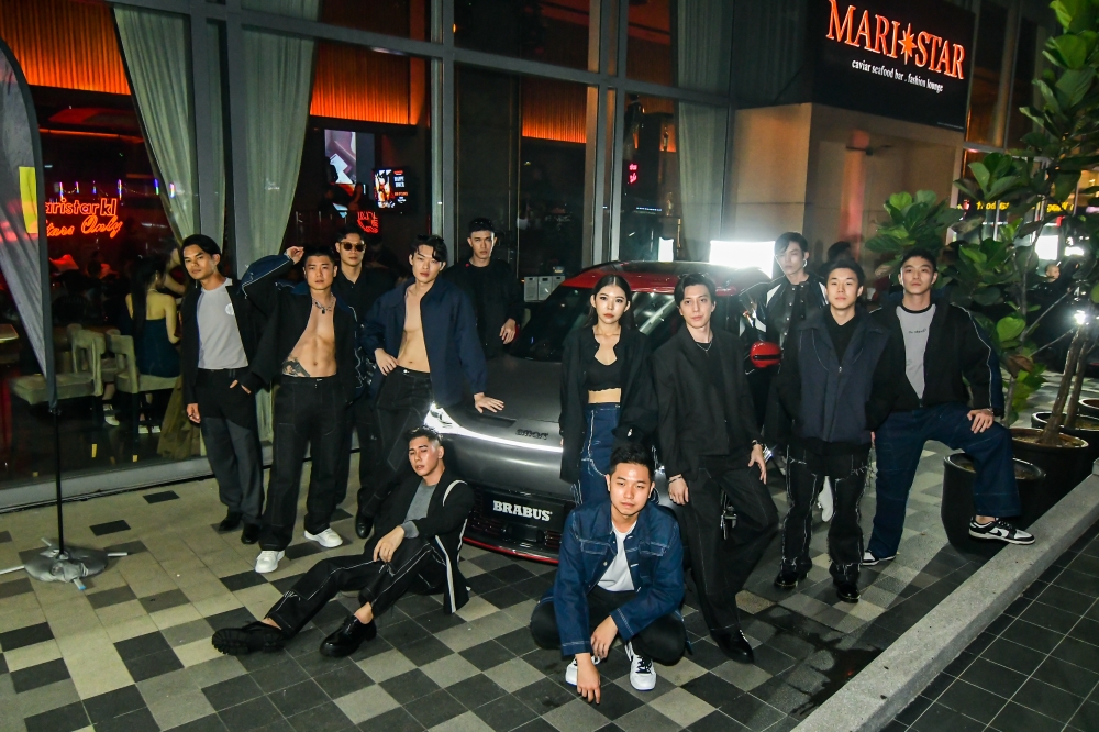 Lee and models posing with a smart car during the 'Fashionista' event at popular dining establishment Maristar. — Picture courtesy of The Marini's Group