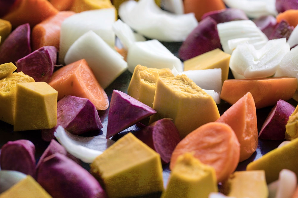 Coarsely chop all the vegetables – pumpkin, purple sweet potatoes, carrots and onion.