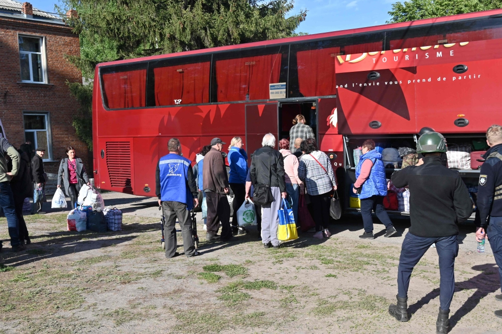 Ukrainian volunteers evacuate residents from settlements in the north of the Kharkiv region, on May 10, 2024, amid the Russian invassion in Ukraine. — AFP pic