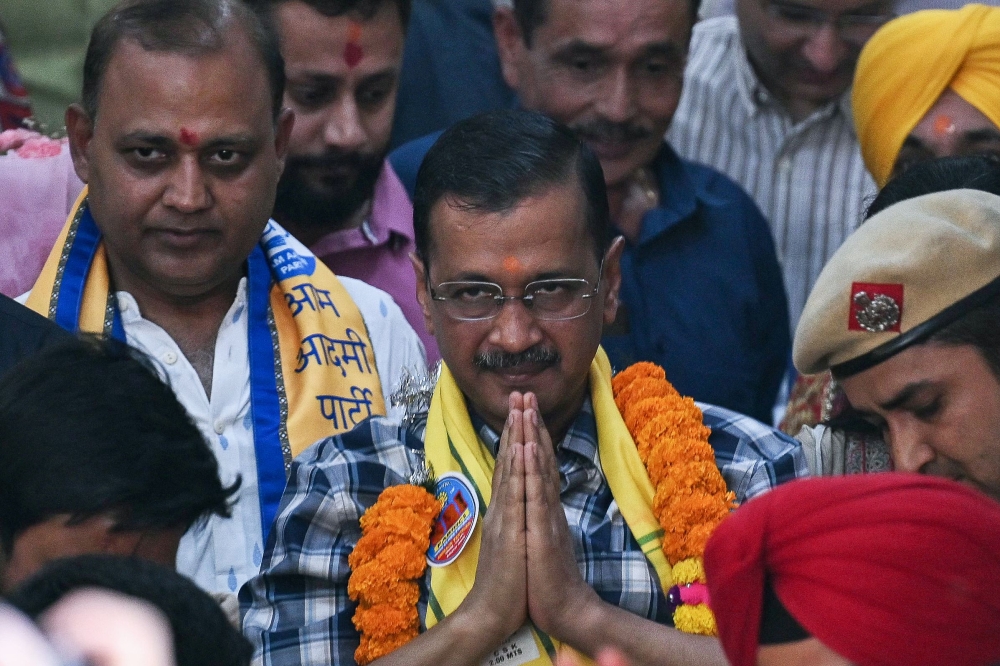 Arvind Kejriwal (centre), chief minister of the capital Delhi and leader of the Aam Aadmi Party (AAP) gestures to supporters during a visit at a Hindu temple in New Delhi on May 11, 2024, a day after being released on bail by India's top court to campaign in the ongoing national election. — AFP pic