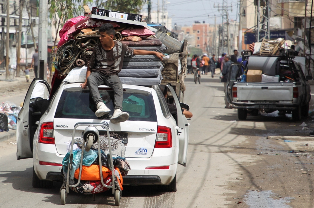A person sits atop a vehicle loaded with belongings, as Palestinians prepare to evacuate, after Israeli forces launched a ground and air operation in the eastern part of Rafah, amid the ongoing conflict between Israel and Hamas, in Rafah, in the southern Gaza Strip, May 11, 2024. — Reuters pic