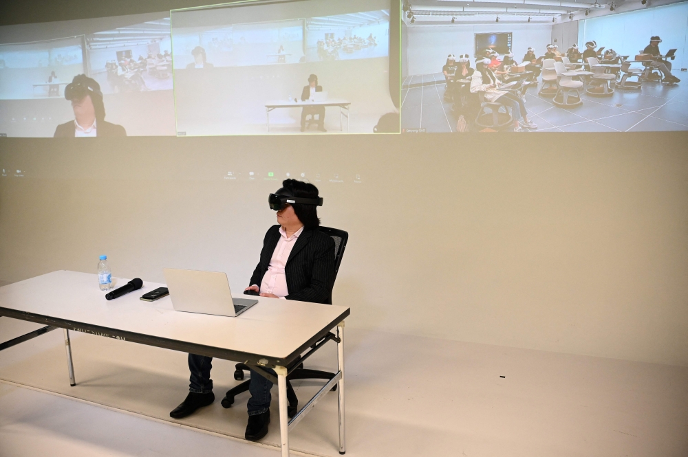 This photo taken on April 9, 2024 shows Pan Hui, a professor leading a project on AI education at the Hong Kong University of Science and Technology (HKUST), teaching a class at the university in Hong Kong. — AFP pic