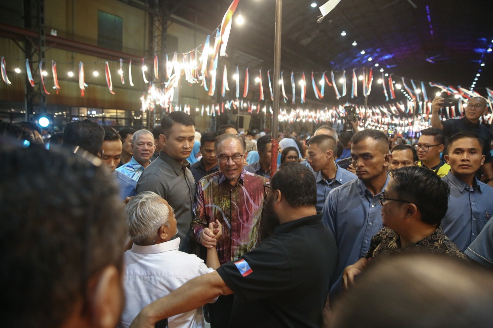 Prime Minister Datuk Seri Anwar Ibrahim (centre) mingles with party members during the PKR's 25th Anniversary celebrations at Sentul Depot in Kuala Lumpur May 11, 2024.— Picture by Yusof Mat Isa
