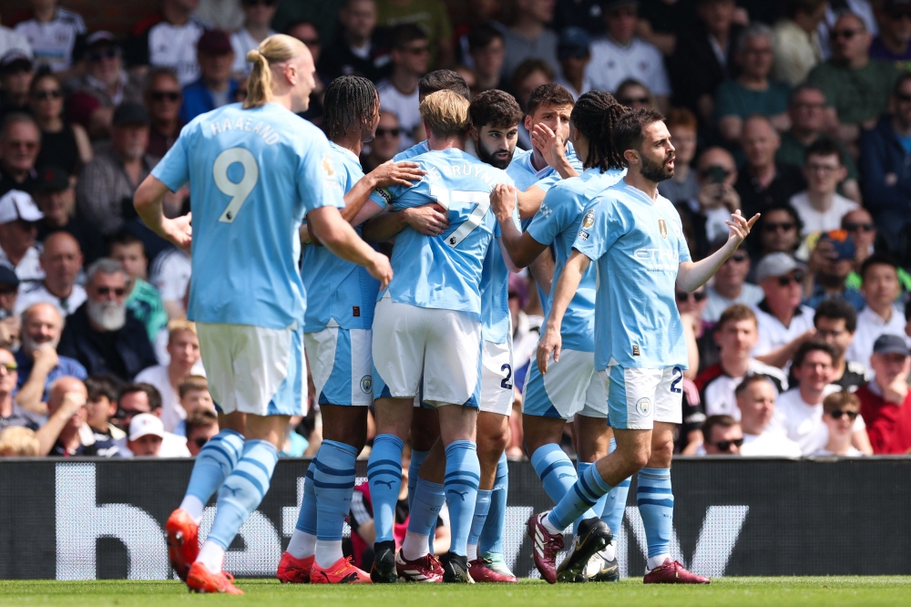 Manchester City’s Croatian defender #24 Josko Gvardiol (Centre) celebrates with teammates after scoring the opening goal during the English Premier League football match between Fulham and Manchester City at Craven Cottage in London on May 11, 2024. — AFP pic