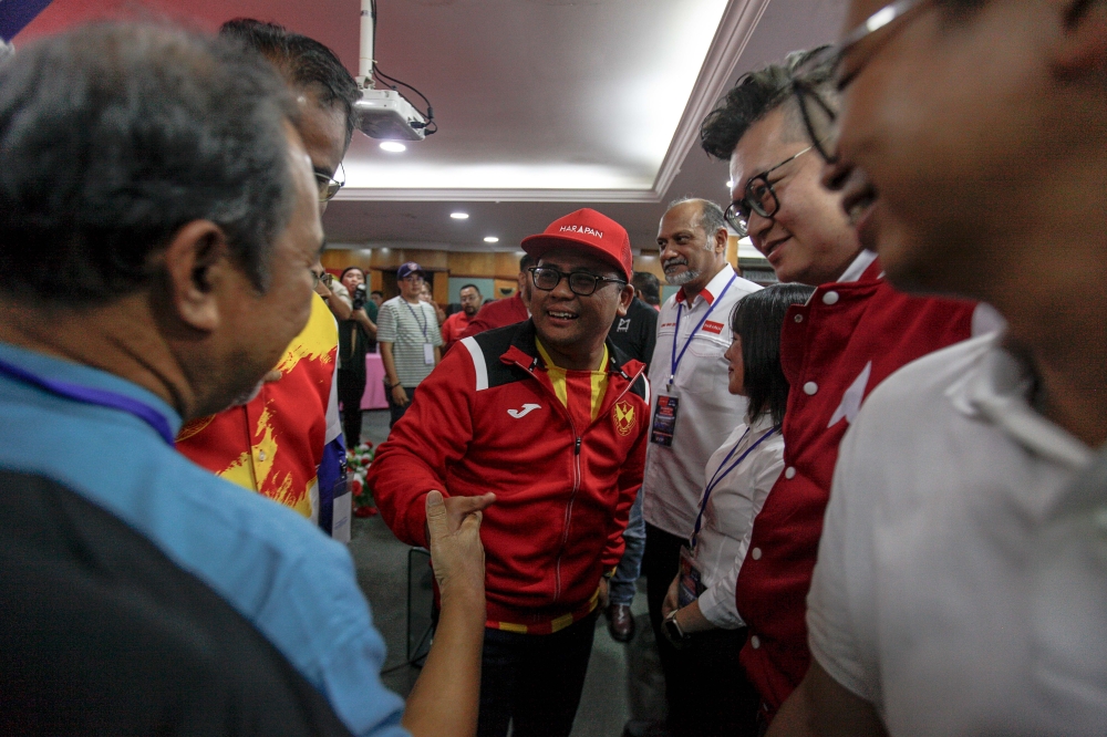 Selangor Pakatan Harapan Chairman Datuk Seri Amiruddin Shari greeting party member as they wait for the announcement of the winner of the N.06 Kuala Kubu Bharu By-Election at Kuala Kubu Bharu Umno office, May 11, 2024. — Picture by Sayuti Zainudin