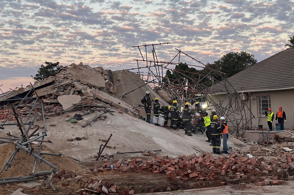 Rescuers and onlookers cheered and applauded yesterday as a survivor emerged after 116 hours from underneath the rubble of a collapsed building in South Africa, with the tragedy having killed at least 13. — AFP pic