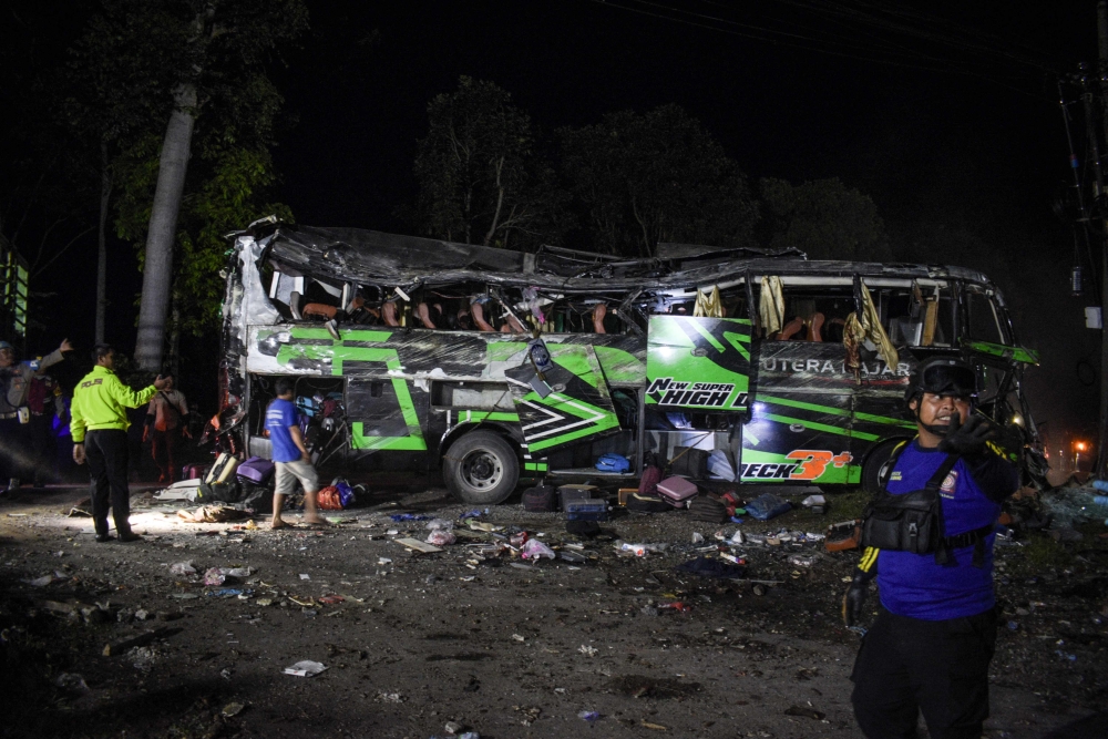 At least eleven people were killed and dozens more were injured when a bus carrying high school students on a graduation trip crashed on Indonesia’s biggest island, police said today. — AFP pic