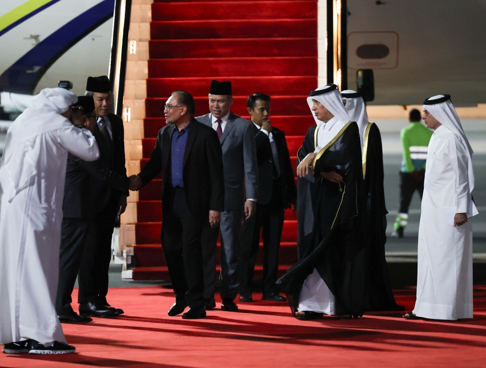 Prime Minister Datuk Seri Anwar Ibrahim disembarks from his plane as he arrives at the Doha International Airport May 13, 2024. — Bernama pic