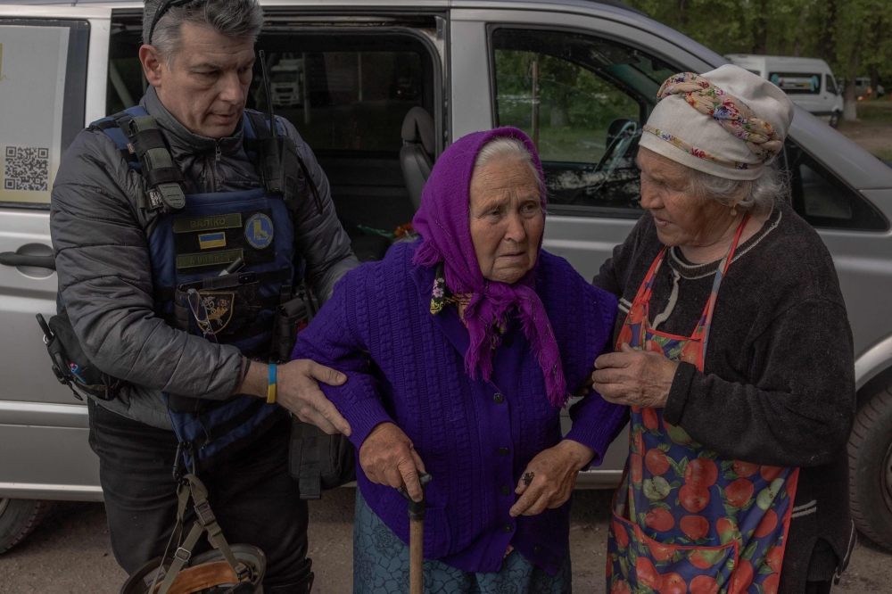 On Sunday, groups of people evacuated from around the border town of Vovchansk, most of them elderly and disoriented. — AFP pic
