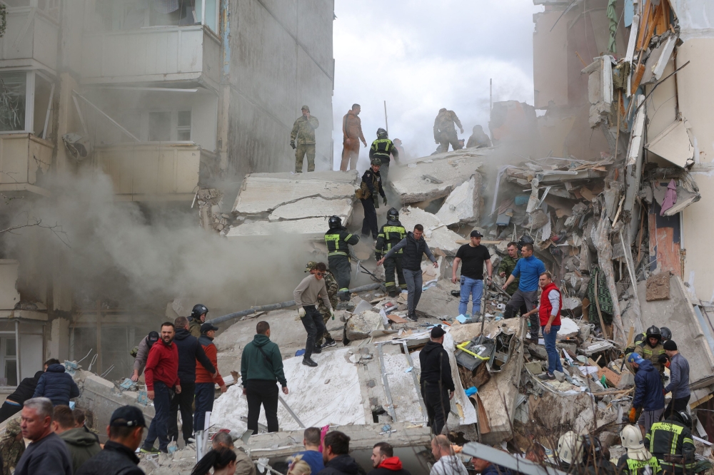 At least 15 people were killed and scores injured yesterday when a section of a Russian apartment block collapsed after being struck by fragments of a Soviet-era missile, launched by Ukraine and shot down by Russia, Russian officials said. — Reuters pic