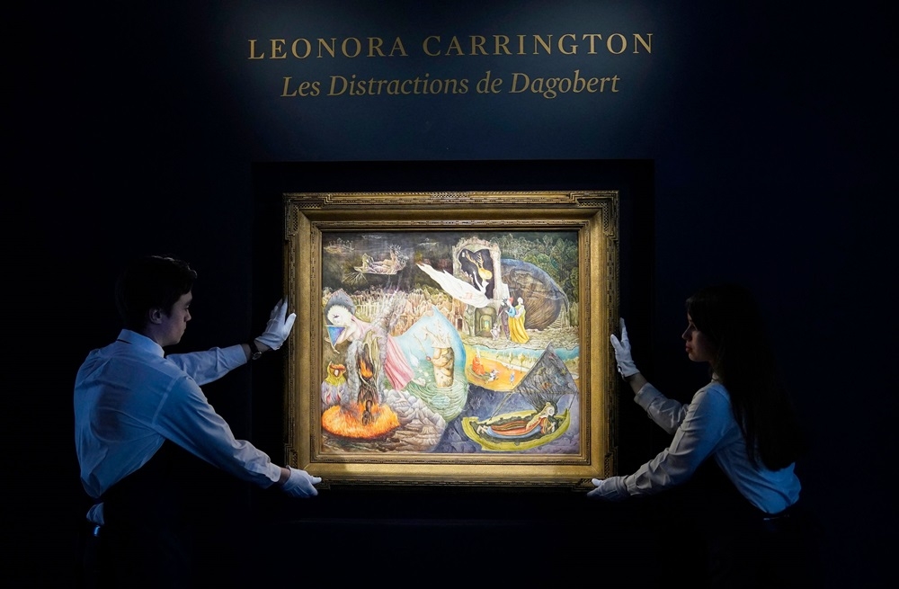 Sotheby’s art handlers hold Leonora Carrington’s ‘Les Distractions de Dagobert’ during a media preview for Sotheby’s upcoming ‘New York Marquee Evening Sales’ on May 3, 2024, in New York City. — AFP pic