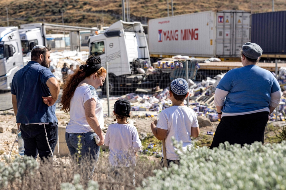 Israeli protesters blocked aid trucks headed for Gaza yesterday, strewing food packages on the road. — AFP pic