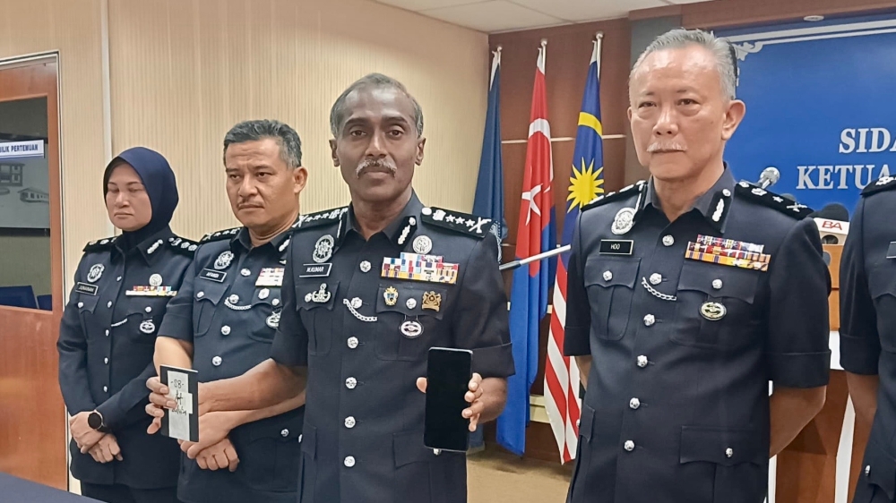 Johor police chief M. Kumar (third from left) with other senior officers behind the anti-vice operation at a press conference held at the state police headquarters in Johor Baru May 14, 2024 — Picture by Ben Tan
