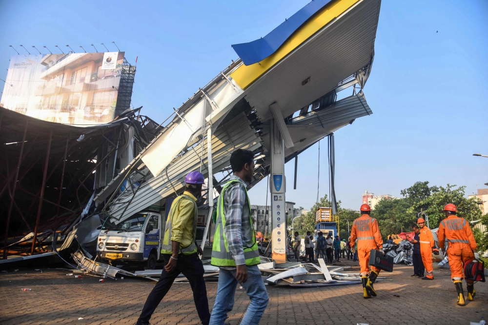 Police in India’s financial capital have opened a criminal case against the owner of a huge billboard that collapsed on a petrol station and killed 14 people, media reports said Tuesday. — AFP pic