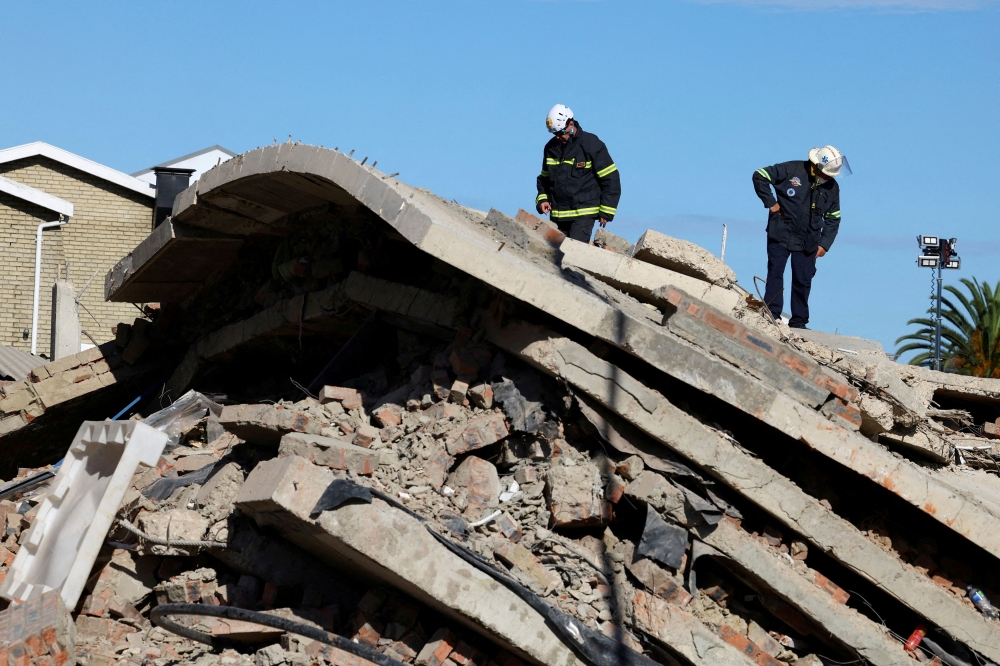 The death toll from the collapse of a building in South Africa has risen to 30, with another 22 people still missing, authorities said yesterday, a week after the structure came crashing down. — Reuters pic